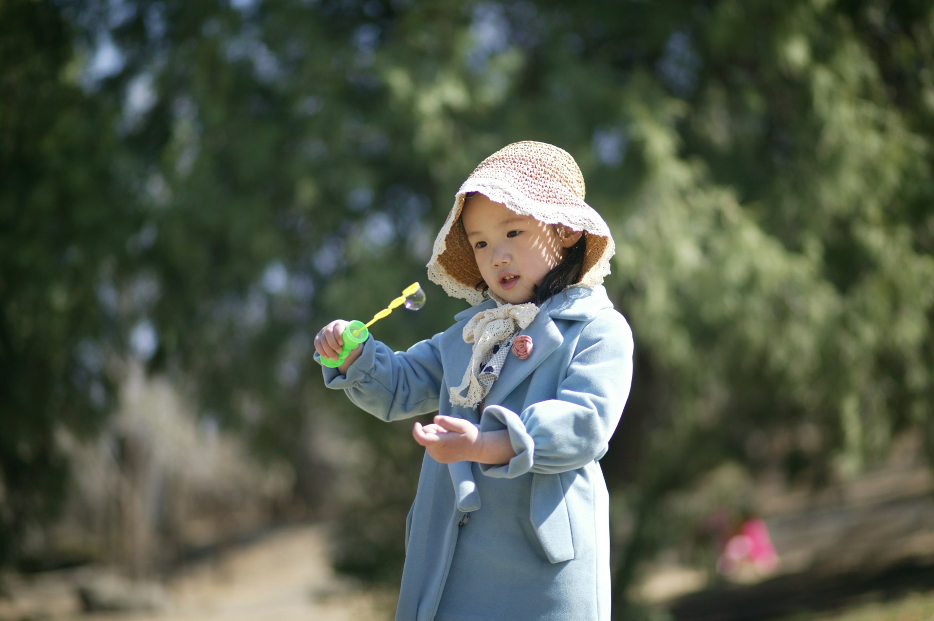 a little girl holding a toothbrush in her hand